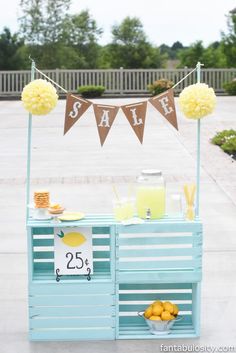 a blue cart with lemons and drinks on it