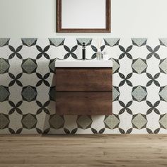 a bathroom with a sink, mirror and tiled wall