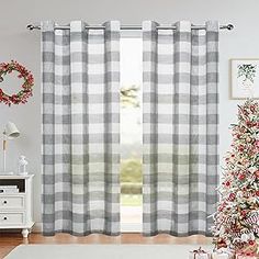 a living room decorated for christmas with plaid curtains