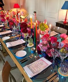 the table is set with flowers, candles and napkins for dinner guests to enjoy