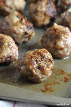 some meatballs are sitting on a baking sheet with the words classic meatballs above them