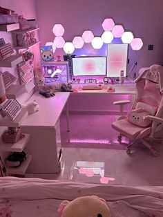 a bedroom with a teddy bear sitting on the bed in front of a computer desk