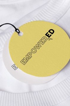 a white t - shirt with a yellow tag that says empo power on it