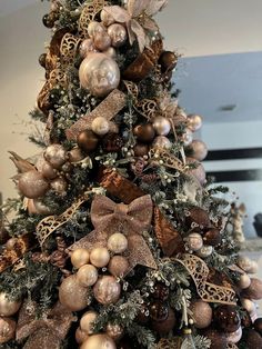 a christmas tree decorated with ornaments and bows