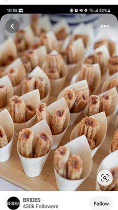 small desserts are lined up on a wooden tray