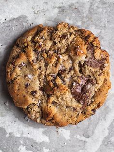 a chocolate chip cookie sitting on top of a table