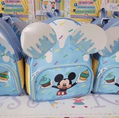 several mickey mouse backpacks with cupcakes and frosting on them for sale