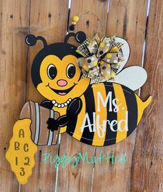 a wooden sign with a bee holding a barrel and the words mrs allred written on it