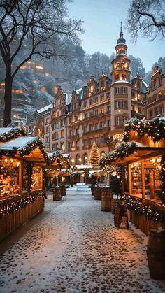 a snowy street with christmas decorations and lights