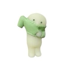 a green and white stuffed animal with a scarf around it's neck, on a white background