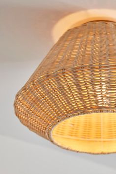 a wicker light fixture hanging from the ceiling