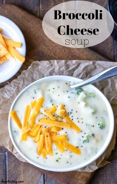 broccoli cheese soup in a white bowl on top of a wooden cutting board