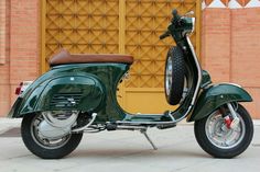 a green scooter parked in front of a building