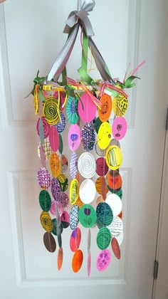 a door hanger made out of paper and buttons with a bow hanging from it