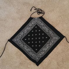 a black and white bandana laying on the ground