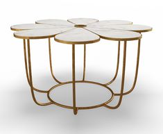 four tables with white marble tops and gold metal bases, set on top of each other