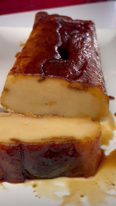 two slices of cheesecake on a plate with sauce drizzled around it