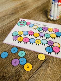 a close up of a board game on a table with crayons and markers