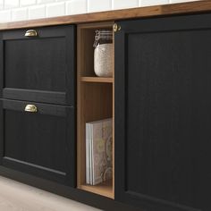 a black cabinet with two doors and drawers