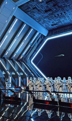 a scene from star wars the force awake with stormtroopers lined up on stage