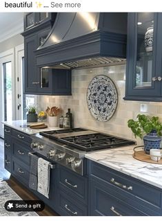 a kitchen with blue cabinets and white marble counter tops is featured in the instagram