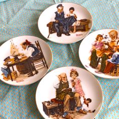 four plates with pictures of people on them sitting on a blue and white tablecloth