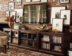 an entertainment center with pictures on the wall and bookshelves in front of it