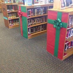 several bookshelves with presents wrapped in green and red