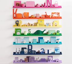 the colorful shelves are filled with toys and other things to play with in the room