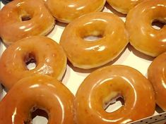 several glazed doughnuts in a box ready to be eaten