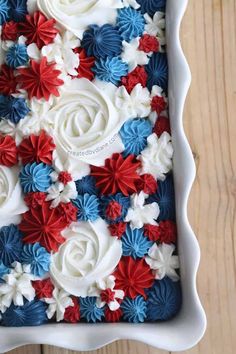 red, white and blue frosted flowers in a square dish