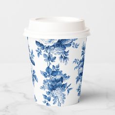 a blue and white coffee cup sitting on top of a marble counter