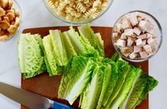 lettuce, chicken and pasta on a cutting board