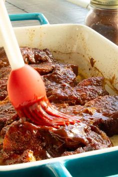 a spatula is being used to stir up some food in a casserole dish