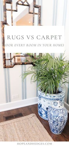 a blue and white vase sitting on top of a wooden floor next to a mirror