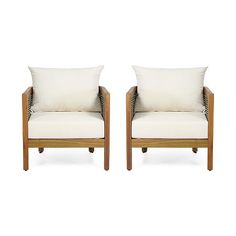 two chairs with white pillows on them sitting side by side in front of each other