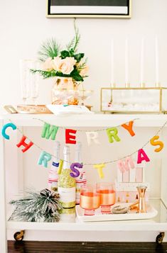 a bar cart filled with drinks and condiments for a birthday party or bridal