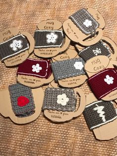 small crocheted cell phone cases sitting on top of a brown cloth covered table