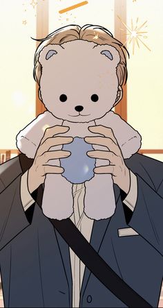 a man holding a teddy bear in his hands