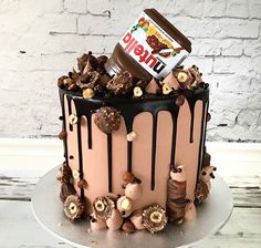 a cake with chocolate frosting and candies on top