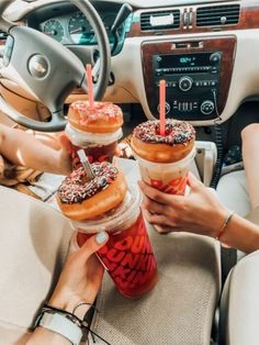 three donuts and two drinks are in the car