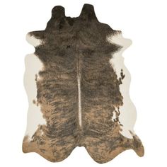 a brown and white cowhide rug with black spots on the bottom, in front of a white background