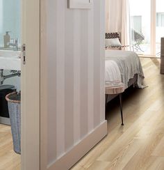 an open door leading to a bedroom with white walls