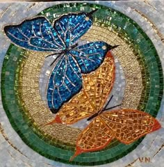 two blue butterflies sitting on top of a mosaic