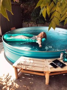 a woman laying in a pool with an inflatable mattress