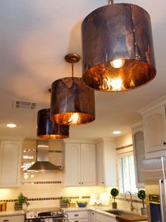 two lights hanging from the ceiling in a kitchen