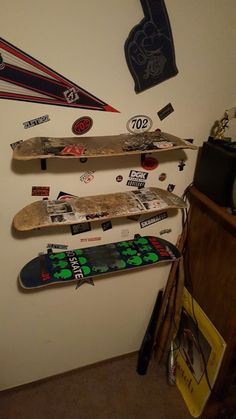 there are many skateboards hanging on the wall