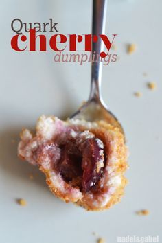 a close up of food on a fork with the words, quark cherry dumplings