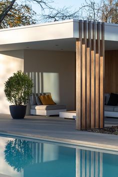 an outdoor living area next to a swimming pool