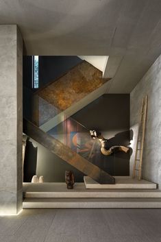 the stairs in this modern house are made out of concrete and steel, with an artistic painting on them